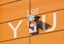 a security camera mounted to the side of a building